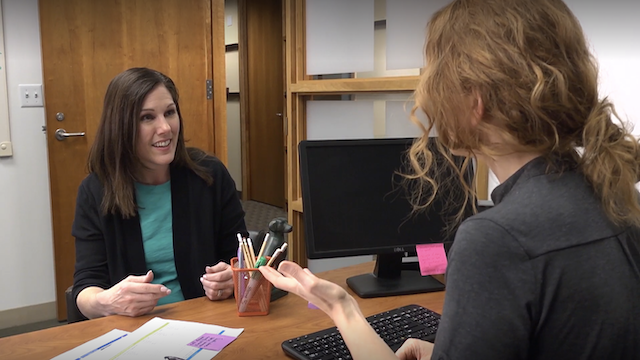 Female employee and her boss having a discussion in an office