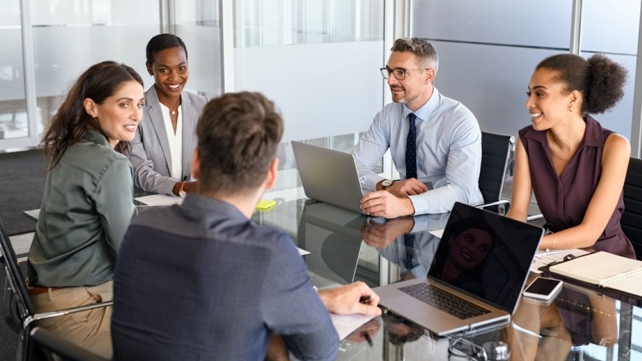 Happy, diverse group of business leaders having a discussion 