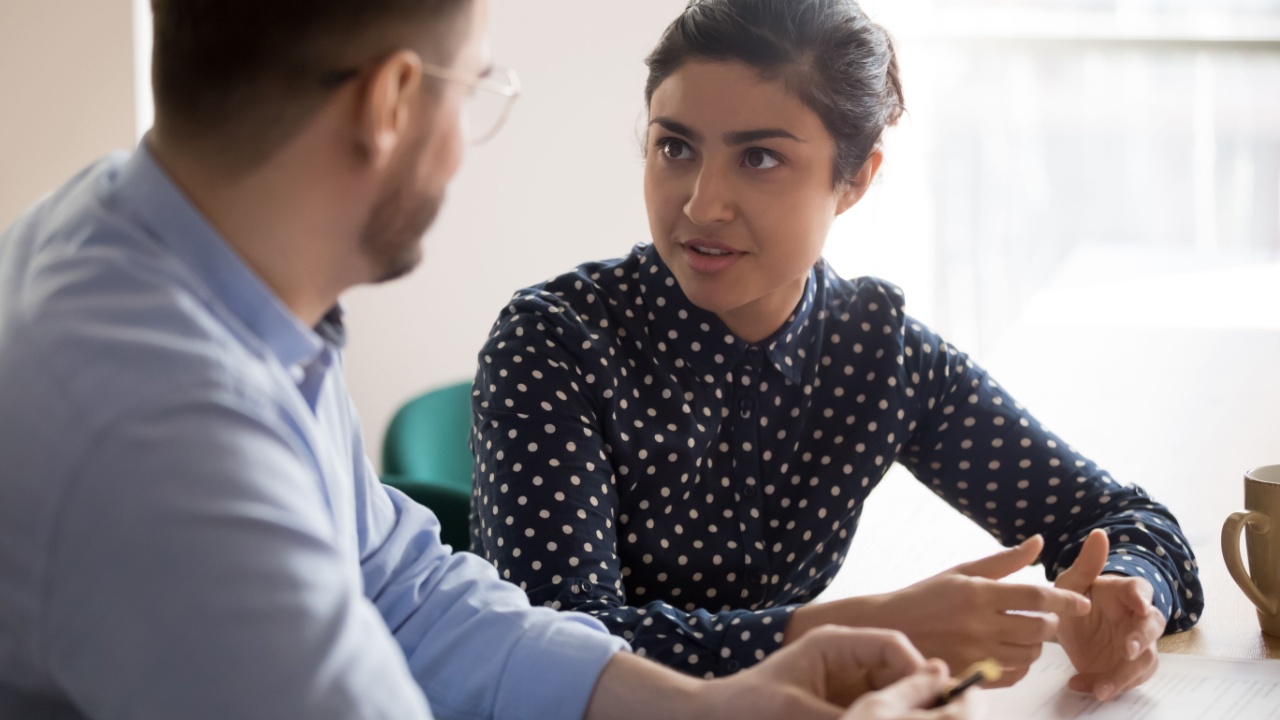 Female manager talking with male employee