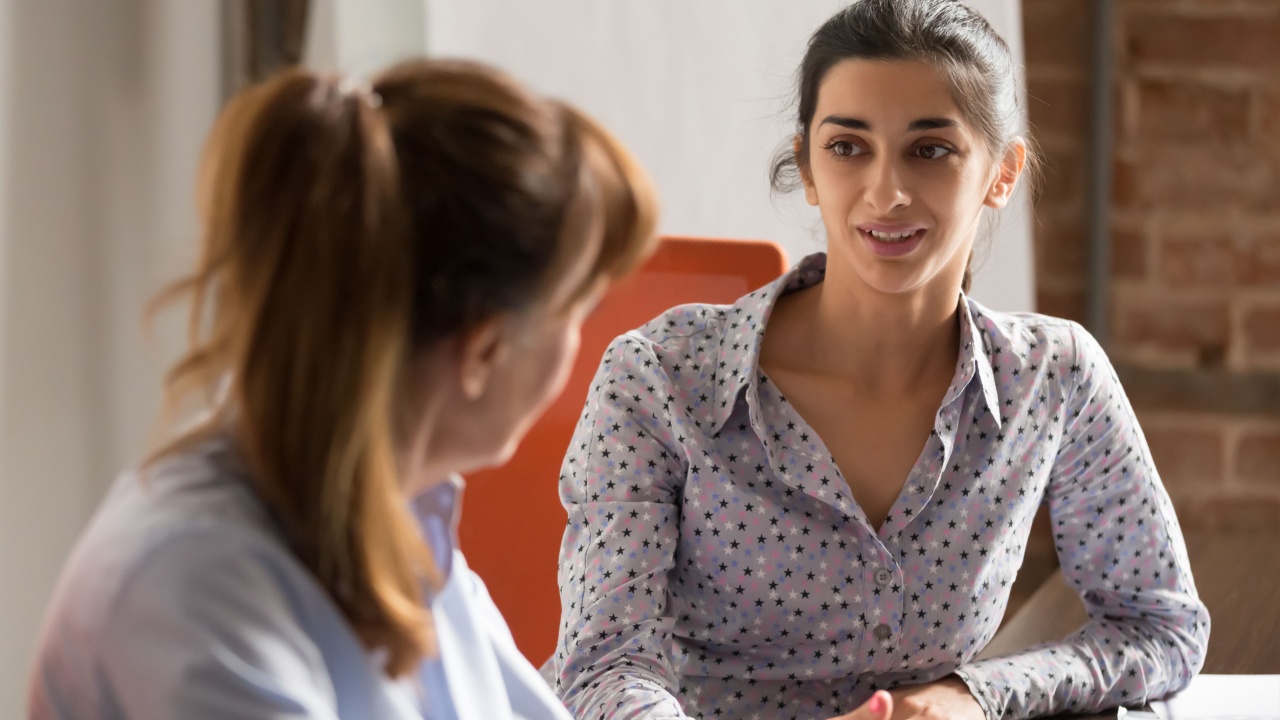 Female employee talking with female manager