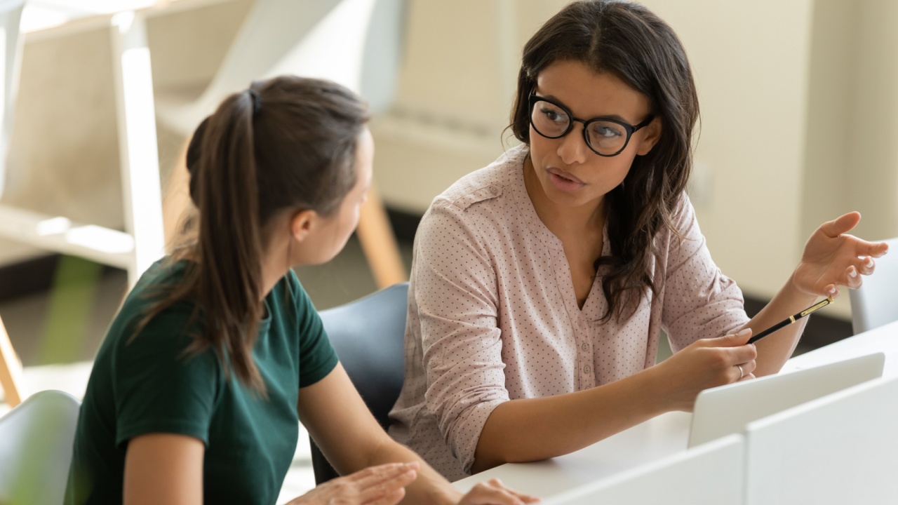 one female employee giving advice to another female employee